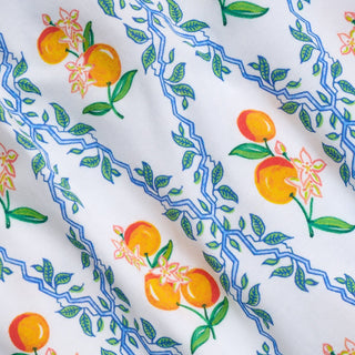 Fabric with colorful peach and floral pattern on a white background