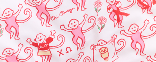 Pink cartoon monkeys with flowers, Greek letters, and banners are printed on a white fabric. Some monkeys wear shirts with Chi Omega and Ω, while others hold signs or dance.