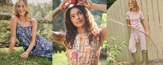 Three women outside: one in a blue floral dress sitting by a fence, one in a floral top holding an apple, and one in a striped dress with boots standing by a wooden fence.