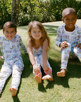 Roller Rabbit kids sitting on grass wearing matching pajamas