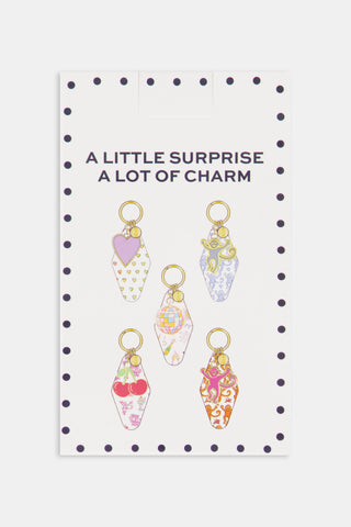 Rectangular Assorted Mystery Box keychain package with a repeating purple heart pattern and text reading Roller Rabbit Mystery Box surrounded by a border of dots.