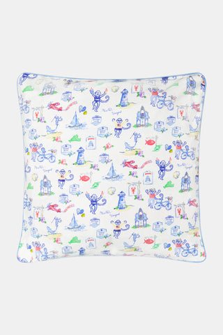 Square pillow with a white background featuring playful blue monkeys, lighthouses, fish, frogs, sailboats, and houses in blue, green, and red. The lively design is arranged in a whimsical, repeating pattern.
