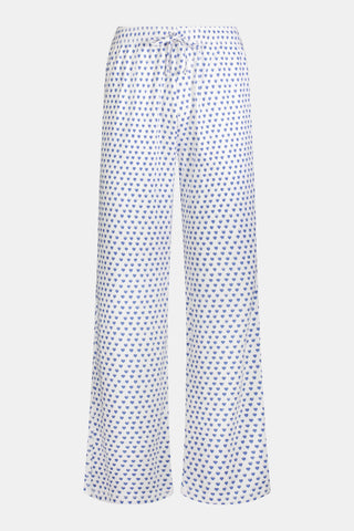 The Roller Rabbit Mens Hearts Simon Pant features white pajama pants with a blue dotted pattern, a drawstring waistband, and wide legs, displayed on a plain white background.
