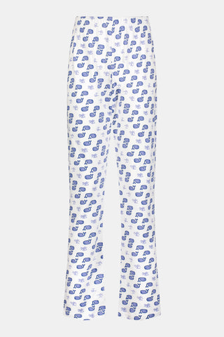 A person stands barefoot against a plain background, one hand in their pocket, wearing Roller Rabbit's Mens Moby Simon Pant—crafted from soft Pima cotton and featuring a blue paisley pattern.