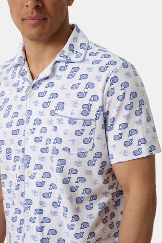 A man models the Mens Moby Louie Pajamas—a white short-sleeved shirt with blue palm trees, anchors, and boxing gloves—part of a matching set. Only his upper body is shown against a plain background.