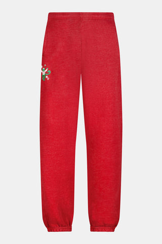 Holly berry red US BLANKS Deck The Halls Bea Sweatpants featuring a small embroidered graphic of a green character wearing a holiday sweater on the right hip.