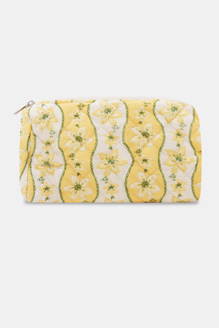 The Lillian Floral Stripe Quilted Makeup Bag by Roller Rabbit is a rectangular makeup bag with a zipper, crafted from quilted cotton fabric in a yellow and white floral stripe pattern accented with green, and is showcased against a plain white background.