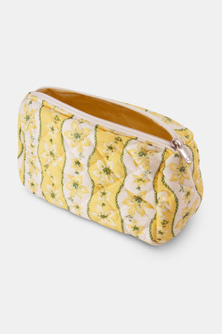 The Lillian Floral Stripe Quilted Makeup Bag by Roller Rabbit is a rectangular makeup bag with a zipper, crafted from quilted cotton fabric in a yellow and white floral stripe pattern accented with green, and is showcased against a plain white background.