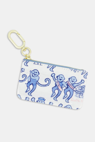The Delta Gamma Monkey Coin Pouch by Roller Rabbit is a small zippered pouch featuring blue cartoon monkeys with sashes labeled “GG” and “Kitten,” set against a white background with whimsical designs and finished with a gold key clip. It’s the perfect sorority accessory or fun gift for Delta Gamma members.