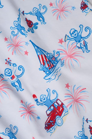 Fabric with blue monkey illustrations, red firecrackers, and white stars on a white background