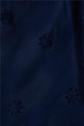 A woman models the Roller Rabbit Vanna Embroidery Margaret Dress—a short-sleeve navy linen shirtdress with a belted waist—standing against a plain light background.