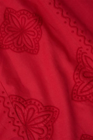 A woman with long curly hair wears the Roller Rabbit Monaco Geo Penelope Dress, a sleeveless, halter-neck, ankle-length red dress with subtle embroidery. She stands forward in open-toed, low-heeled sandals against a plain white background.
