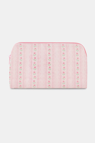 The Daisy Heart Stripe Makeup Bag by Roller Rabbit is a pink cotton canvas cosmetic pouch with a zipper, adorned with a delicate pattern of pink lines and small green and pink floral motifs on a light background.
