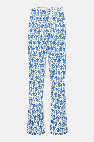 A person stands barefoot against a plain white background, showing only the lower half of their body while wearing Roller Rabbit Mens Monkey Simon Pant pajama pants.