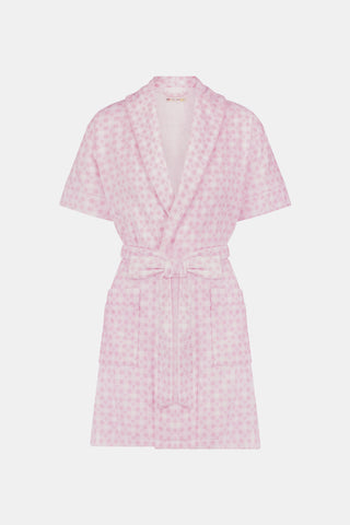 The Roller Rabbit Gingham Hearts Brooks Robe features a light pink gingham pattern with subtle hearts, crafted from soft cotton. This short-sleeve robe includes front pockets and a matching waist tie, and is displayed against a plain white background.