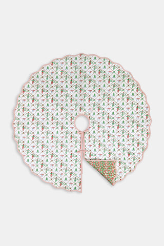 Round SAPPHIRE Deck The Halls/Holly Berry Tree Skirt featuring a white quilted pattern of holly, snowmen, and dancing elves with a scalloped pink edge, partially folded to reveal an 80s printed green and red holly-patterned underside.