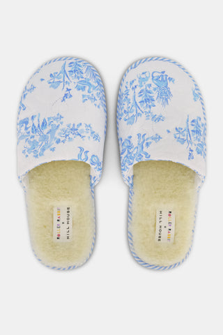 A pair of Sherwood Forest Monkey Quilted Slippers by Roller Rabbit with plush faux-shearling lining and blue floral patterns, displayed side by side on a white background.