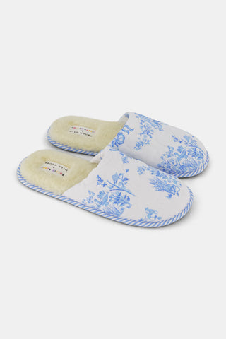 A pair of Sherwood Forest Monkey Quilted Slippers by Roller Rabbit with plush faux-shearling lining and blue floral patterns, displayed side by side on a white background.