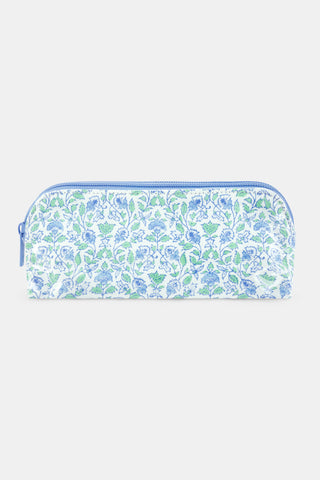 The Roller Rabbit Garden Gate Floral Makeup Bag features a rectangular zippered design with a blue and green floral pattern on a white cotton canvas background, photographed against a simple light backdrop. Perfect for organizing your beauty essentials at home or while traveling.
