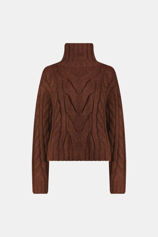 A person wearing a cozy, chocolate brown Naomi Sweater by REVOLUTION KNITS, featuring a cable-knit design and a high turtleneck.