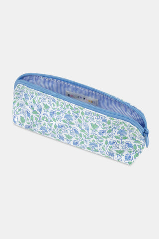 The Roller Rabbit Garden Gate Floral Makeup Bag features a rectangular zippered design with a blue and green floral pattern on a white cotton canvas background, photographed against a simple light backdrop. Perfect for organizing your beauty essentials at home or while traveling.