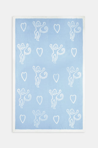 Folded light blue and white Monkey Hearts Dreams Blanket featuring a pattern of monkey faces and hearts.