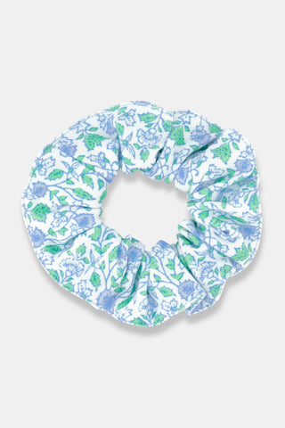 The Garden Gate Floral Scrunchie by Roller Rabbit features a blue and green floral pattern on white cotton, styled in a circular shape against a simple, light background.