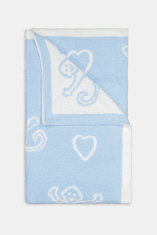 Folded light blue and white Monkey Hearts Dreams Blanket featuring a pattern of monkey faces and hearts.