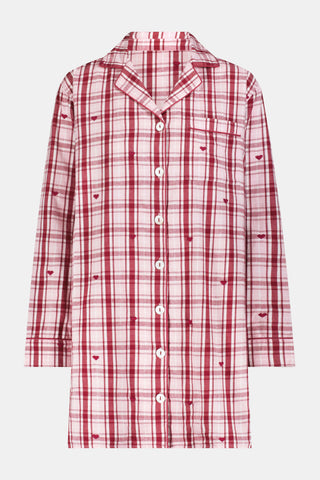 A woman wearing a SAPPHIRE Plaid Hearts Perlita Night Shirt in a pink and maroon plaid pattern with small hearts.