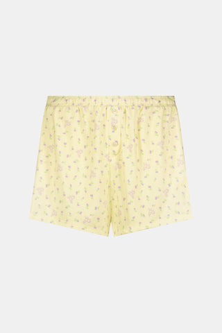 The Mini Monkey Blossom Brooklyn Boxer by Roller Rabbit features light yellow Pima cotton with a delicate pastel floral print and an elastic waistband. Displayed on a plain white background, these comfortable women’s loungewear sleep shorts are perfect for relaxing at home.