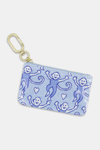 Introducing the Lovely Monkey Coin Pouch from Roller Rabbit—a compact blue zippered pouch featuring a gold clip, playfully adorned with purple monkeys and heart motifs. Ideal as an essentials holder for your daily needs.