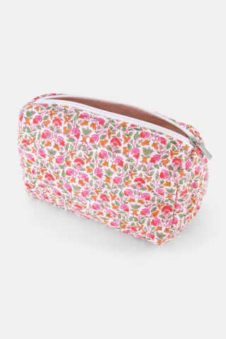 The Roller Rabbit Garden Gate Floral Quilted Makeup Bag is a rectangular, zippered bag crafted from 100 cotton and features a colorful floral print with pink, orange, and green flowers on a white background.