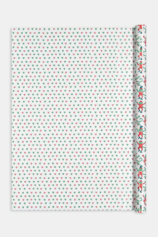 Monkey Mas/Holiday Hearts Wrapping Paper featuring a pattern of green monkeys in Santa hats and outfits on one side, and a pattern of small Holiday Hearts on the other.