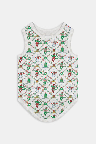 A woman wears a SERFLEX Deck The Halls Bailey Pajamas set featuring a short-sleeved top and shorts with a white background and a repeating Christmas-themed pattern of elves, snowmen, and evergreen trees.