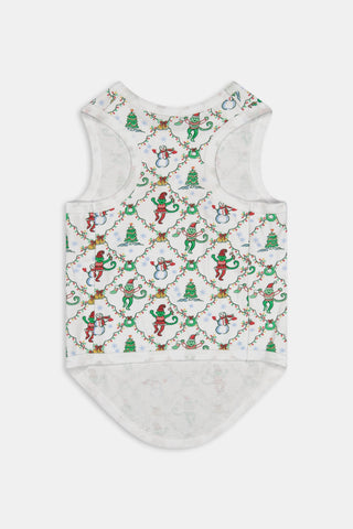 A woman wears a SERFLEX Deck The Halls Bailey Pajamas set featuring a short-sleeved top and shorts with a white background and a repeating Christmas-themed pattern of elves, snowmen, and evergreen trees.