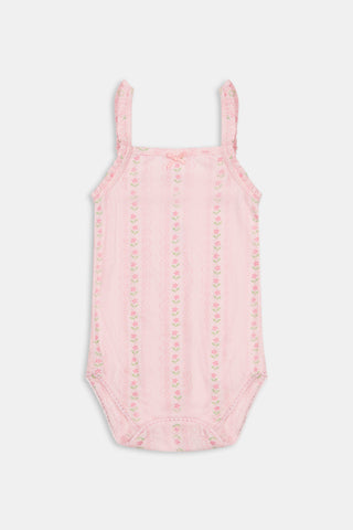 The Roller Rabbit Infant Daisy Heart Stripe Ava Onesie is a pink Pima cotton baby romper with thin shoulder straps, delicate ruffle details, and a subtle floral pattern. This sleeveless design features a small bow at the neckline and is shown against a plain white background.