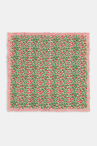 A Holly Berry Napkin Set Of 4 featuring a red berry and green leaf pattern with red-and-white striped borders.