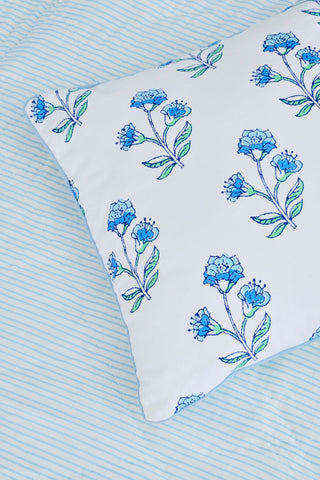 The Roller Rabbit Rosa Floral Decorative Pillow features a white cotton base with blue and light blue floral patterns, green leaves outlined in black, and a thin light blue border—perfect for adding a botanical accent to your decor.