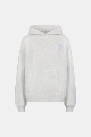 A person is wearing the Roller Rabbit Sleep Club Mimi Sweatpants in light gray, featuring wide legs and crafted from velvety soft Dream Fleece with “Sleep Club” printed in light blue on the left thigh, paired with white sneakers and a cropped white top. The background is plain white.