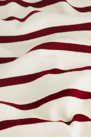 Close-up of the Stripe Brittany Sweater by Roller Rabbit—cream and merlot with horizontal red and white stripes. The soft, wavy texture and evenly spaced pattern showcase the fine cotton-cashmere blend fabric.