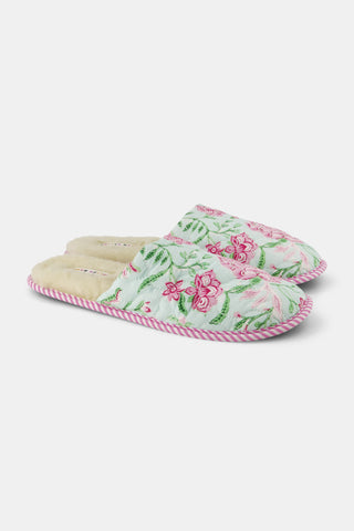 The Camellia Block Quilted Slippers by Roller Rabbit feature a cozy floral pink and green pattern, quilted detailing, a soft fuzzy lining, and pink striped trim around the sole.