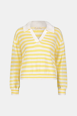 A young woman with light skin and long brown hair wears the Roller Rabbit Striped Rocio Sweater, a pastel yellow, lightweight cotton knit with a wide V-neck and collar. She pairs it with matching drawstring pants and gazes slightly to the side.