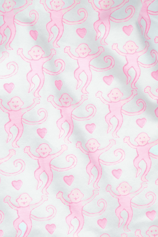 A long-sleeve, footed baby onesie made from 100 Pima cotton, featuring a lovely monkey pattern on a white background with a diagonal two-way zipper closure, from Roller Rabbit's Infant Lovely Monkey Zipper Footie collection.