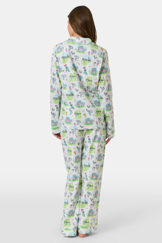 Introducing the Game, Set, Monkey Long Sleeve Polo Pajamas by Roller Rabbit—a cozy white pajama set expertly crafted from soft Pima Cotton. The set features a playful Game Set Monkey print with vibrant green, blue, and yellow animal and nature illustrations. Designed with long sleeves, a button-up polo top, and comfortable drawstring waist pants, this delightful set is showcased against a plain light background.