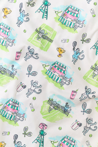 The Roller Rabbit Mens Game, Set, Monkey Troy Pajamas feature a white short-sleeve t-shirt paired with white pajama pants decorated with a vibrant dinosaur and jungle print in green, blue, and black. This playful Pima cotton loungewear set from Roller Rabbit is displayed on a plain white background.