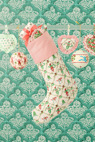 SAPPHIRE Deck The Halls Ruffle Heart Ornament featuring a red and white striped ruffled edge, decorated with an illustrated Christmas tree and holiday lights.