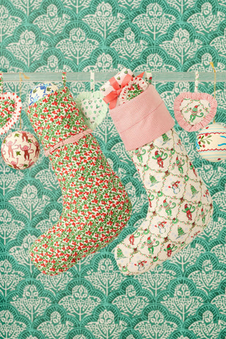 SAPPHIRE Holly Berry Quilted Ruffle Stocking featuring a festive red and green print with a classic modern heirloom design.