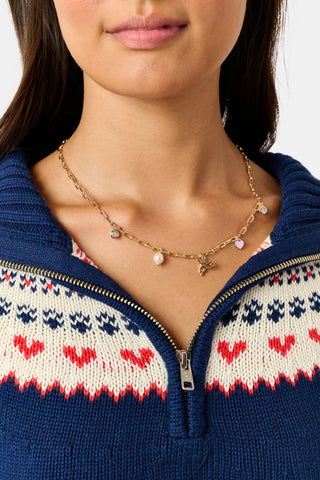 MADISON 501 Monkey Mixed Charm Necklace featuring a gold plated monkey charm, a small heart pendant, a pearl bead, and a circular charm.