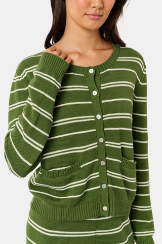 A woman stands facing forward, wearing the Roller Rabbit Autumn Stripe Laine Cardigan in olive green stripes with buttons and matching pants. She has long dark hair and a slight smile.