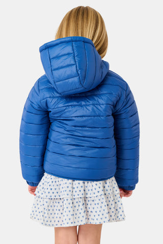 A child wears a blue SOPHISTICA Kids Monkey Reversible Puffer Jacket featuring heart-shaped quilting, a white and light blue chest stripe, and a hood.